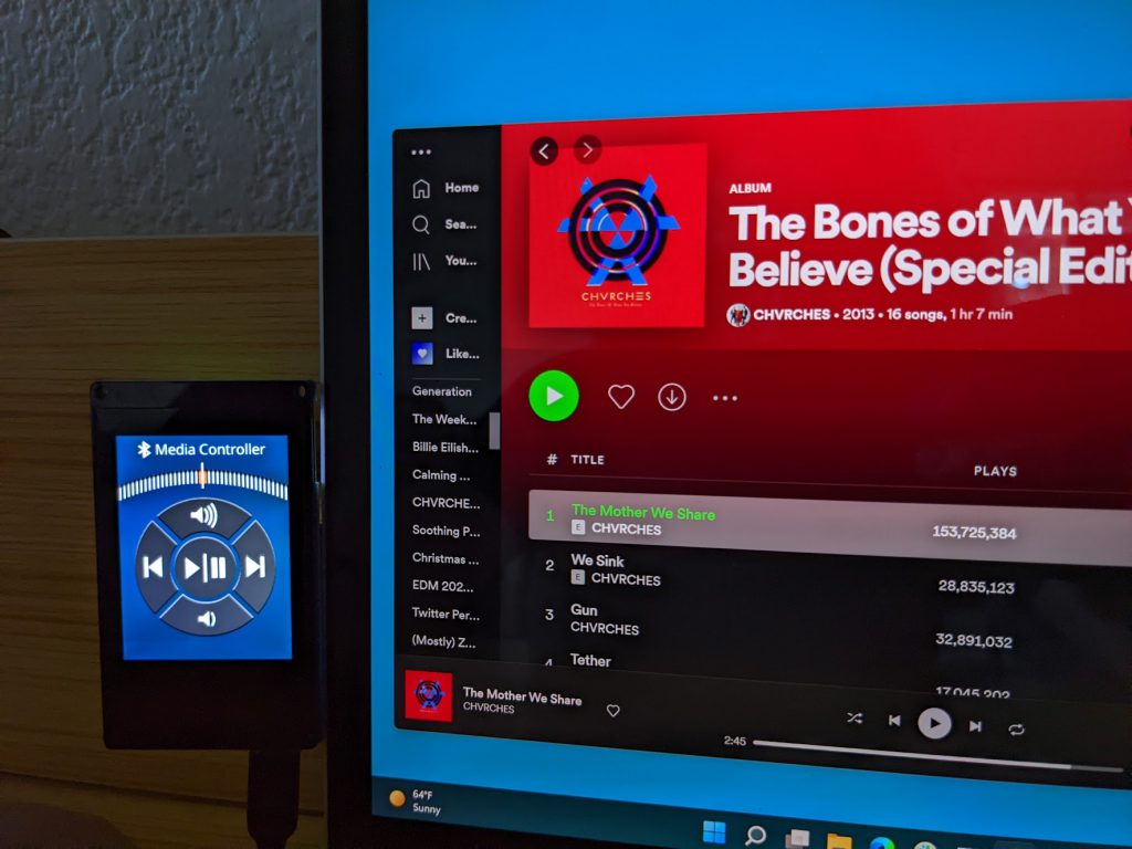 A Moddable Two running the Media Controller app, shown controlling Spotify on a Windows laptop.